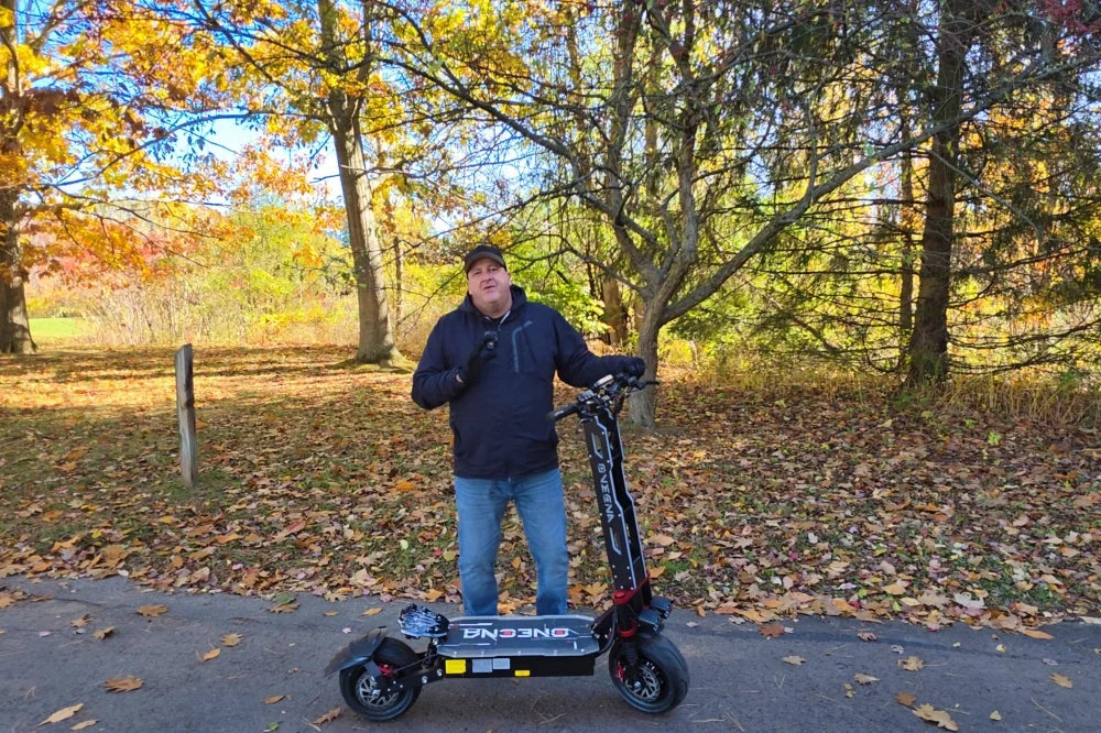 Rider with ONECNA electric scooter with fat tires outdoors