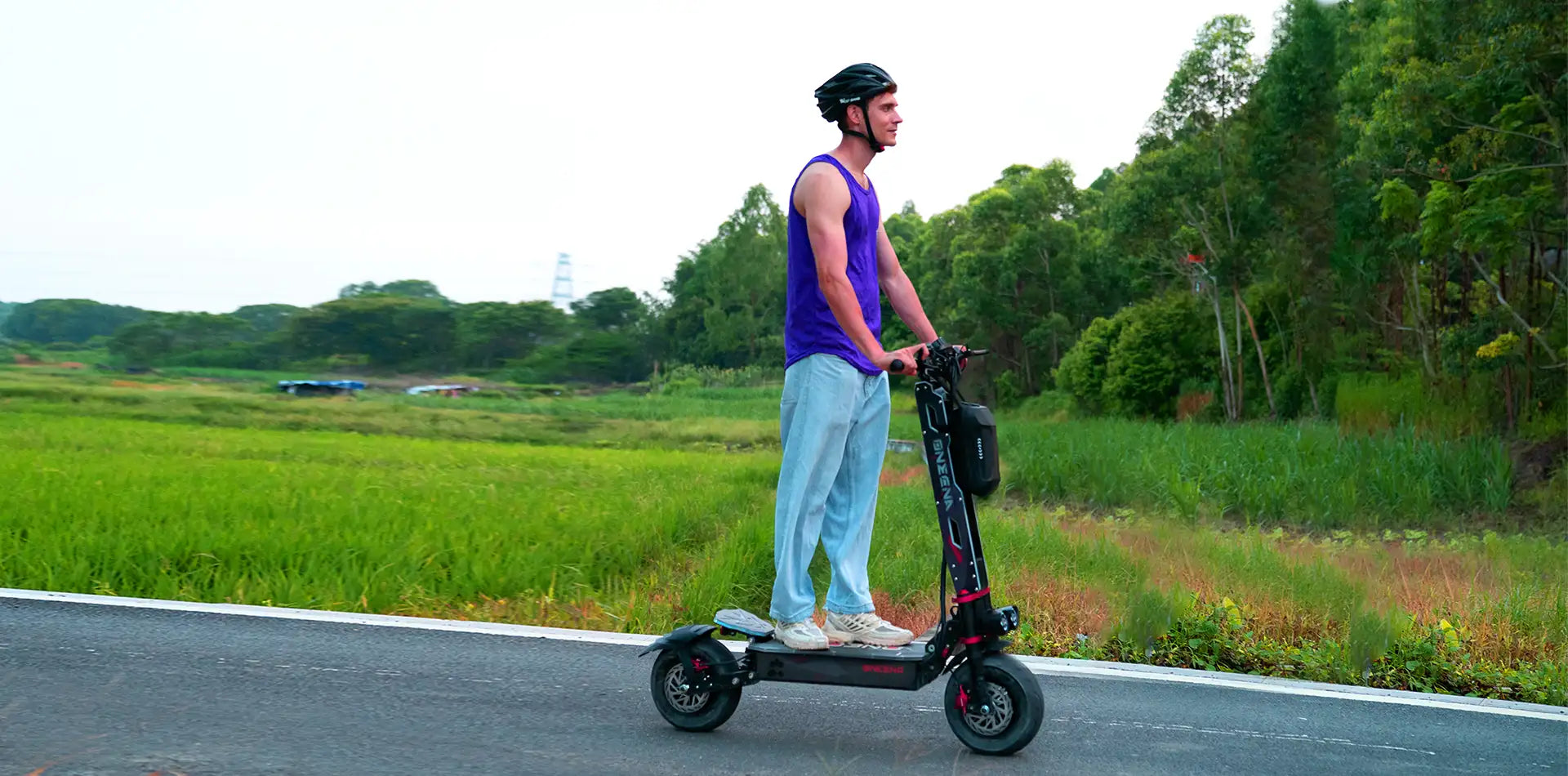Rider wearing helmet on electric scooter on open road - how to maximize electric scooter performance and safety