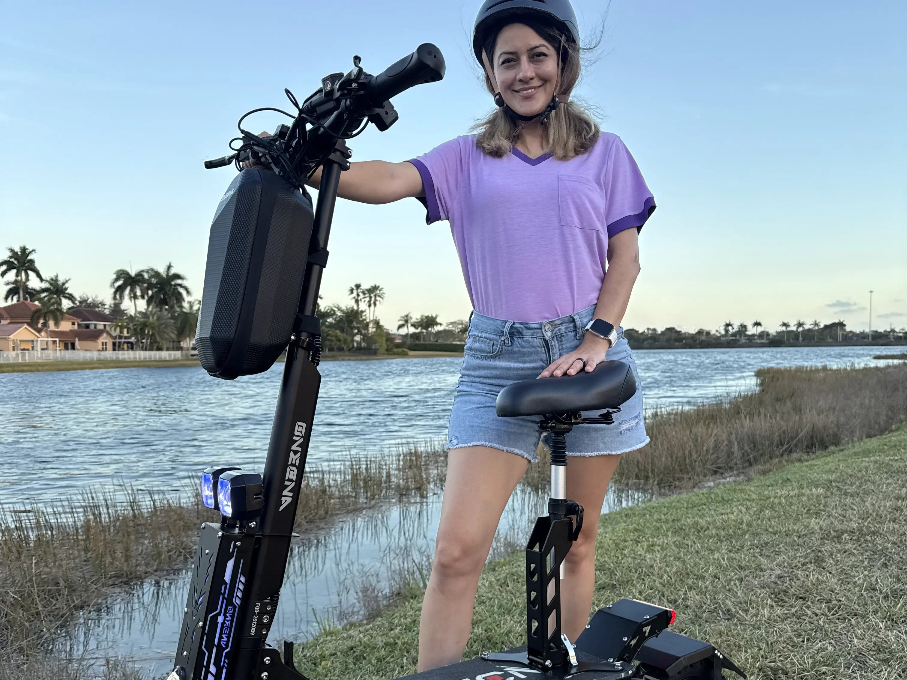 Rider using an electric scooter outdoors on a clear route